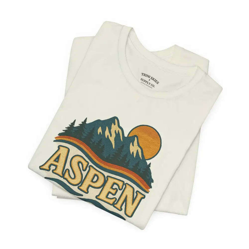 Cream-colored Aspen Lodge Tee with drawn mountain and nature graphic by Trini Skies Supply