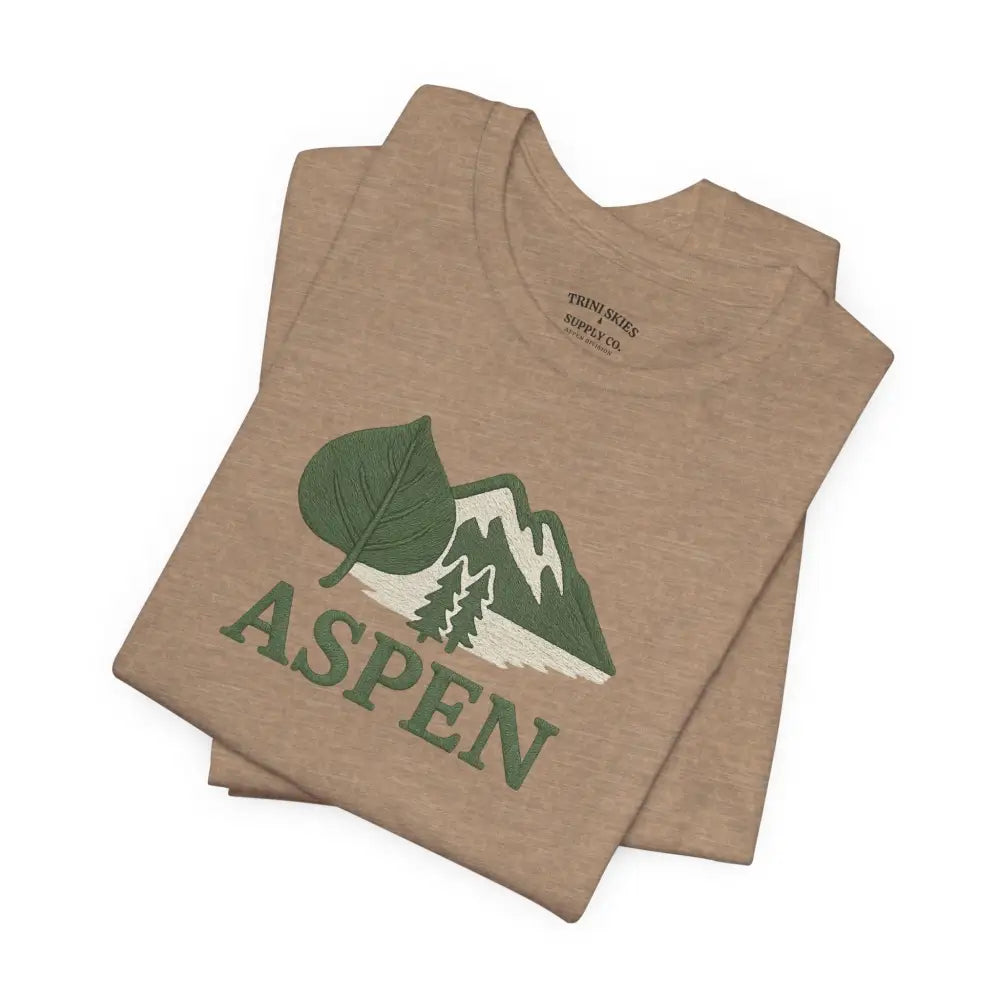 Folded tan Aspen Mountain Tee with green leaf and mountain graphic for outdoor adventure