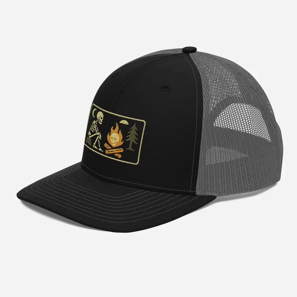 Black trucker hat with skeleton campfire patch and embroidered corduroy design