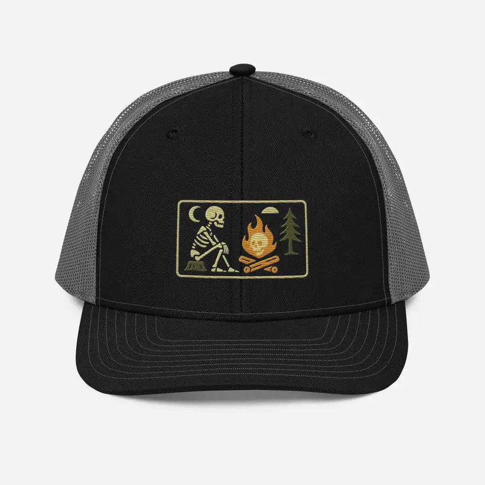 Black and grey mesh trucker hat with skeleton campfire embroidered patch and campfire rectangle patch