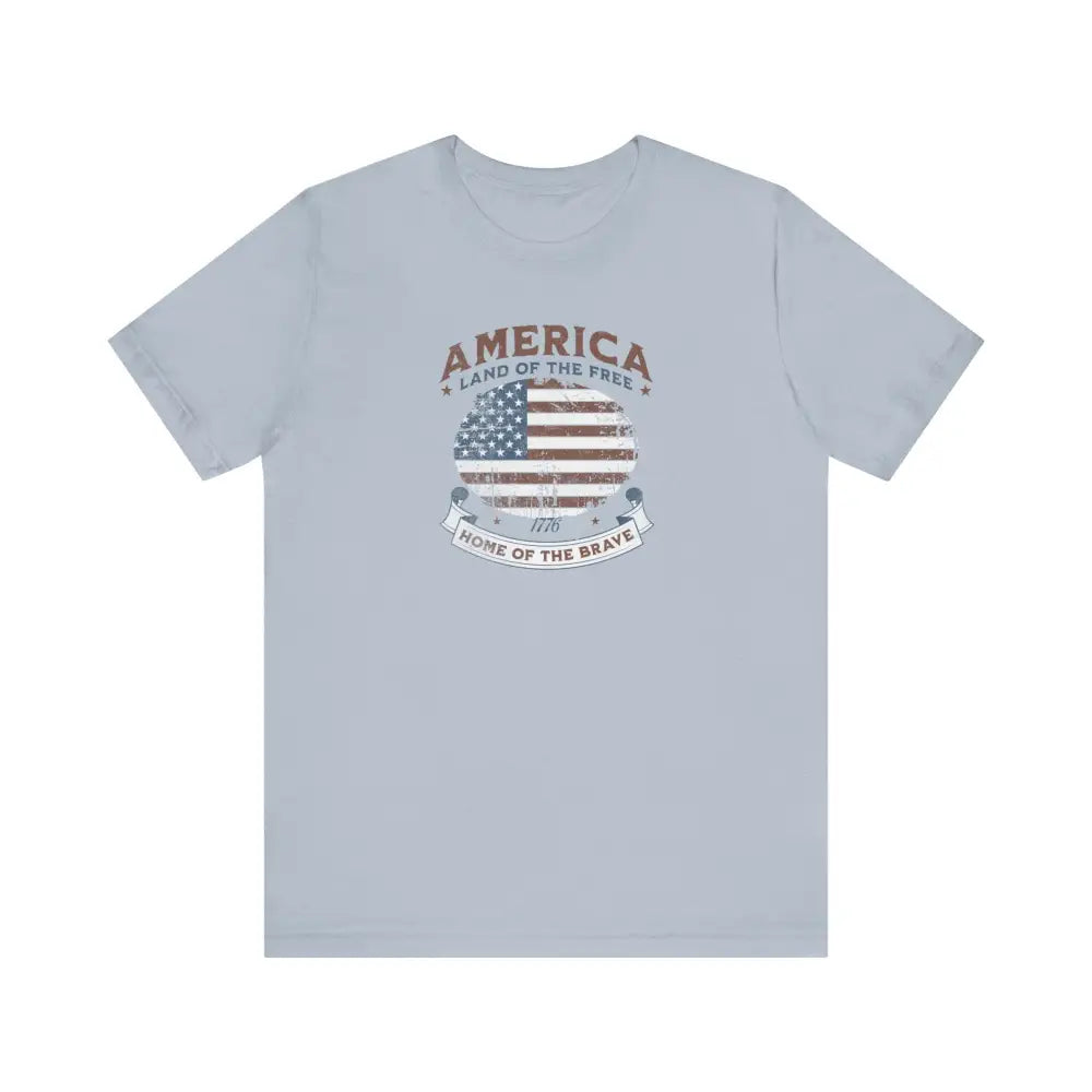 Light blue vintage t-shirt with distressed American flag graphic by Trini Skies