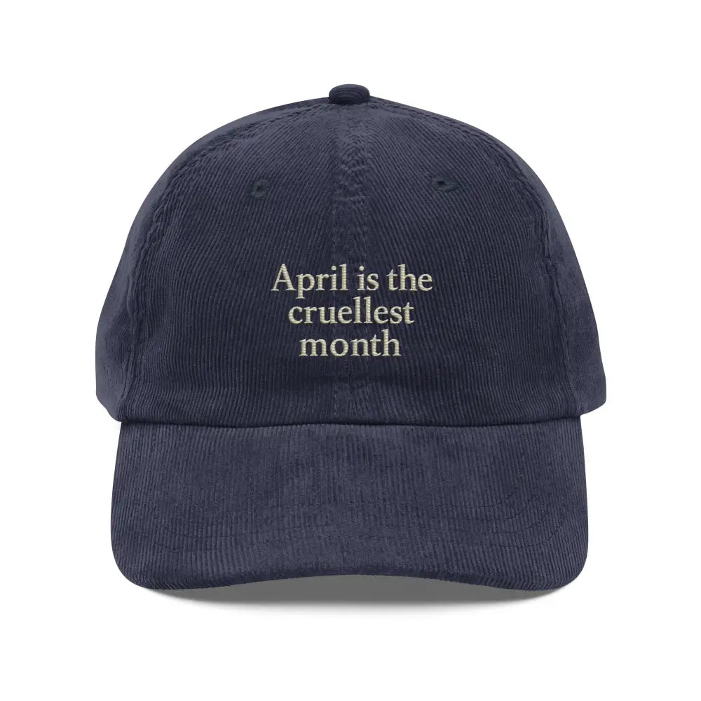 Dark blue corduroy hat with cruellest month embroidery