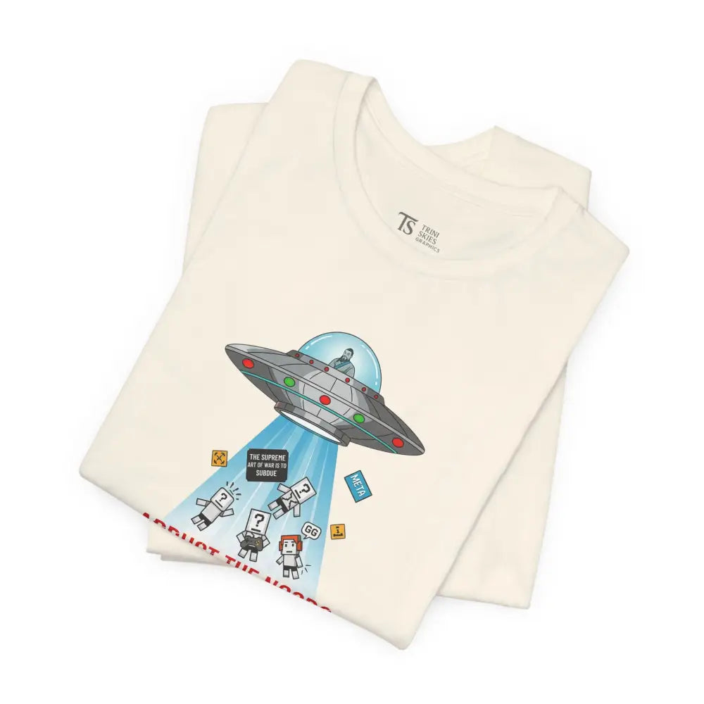 Folded cream-colored Sun Tzu UFO graphic tee with alien humor and pixelated abduction design