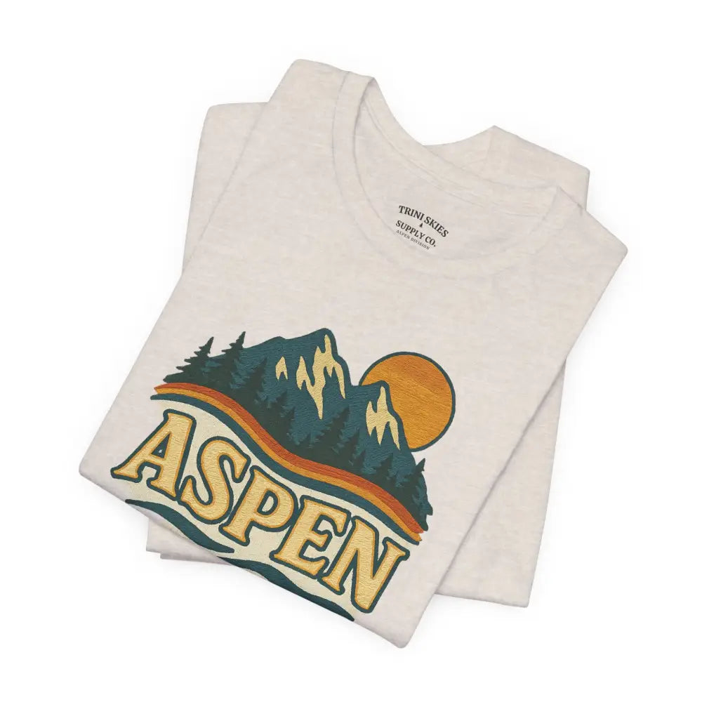 Off-white Aspen Lodge Tee with colorful mountain and sun drawn design features from Trini Skies Supply