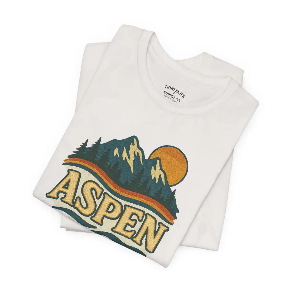 White Aspen Lodge Tee with colorful mountain graphic and Trini Skies Supply drawn design features