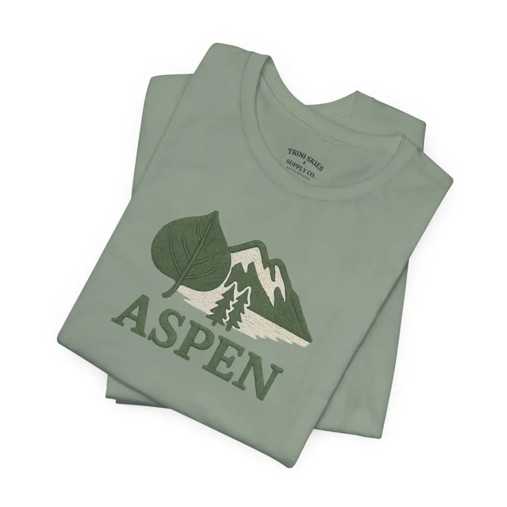 Folded light green Aspen Mountain Tee with embroidered aspen leaf, mountains and trees