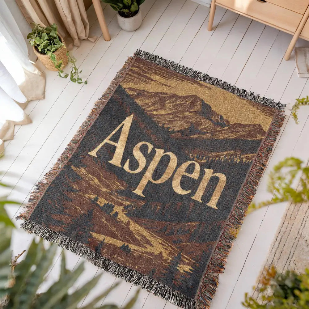 Aspen woven blanket with vintage travel-poster style mountain landscape