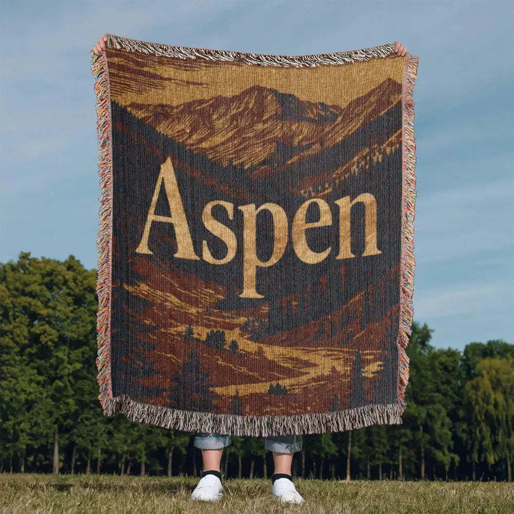 Aspen woven blanket with mountain landscape and gold Aspen text