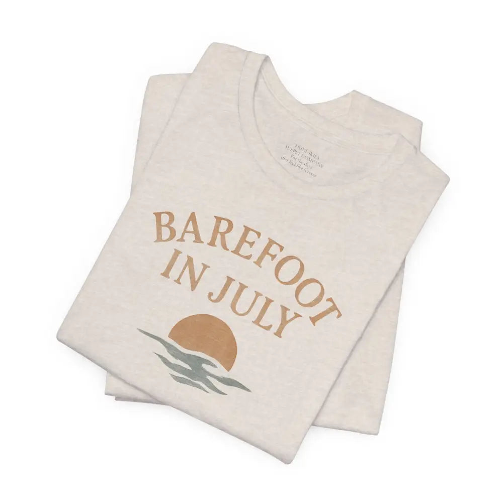 Folded cream-colored July Vintage Tee with graphic design from Trini Skies Supply