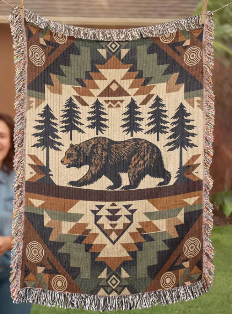 Rustic woodland tapestry throw with woven brown bear in forest