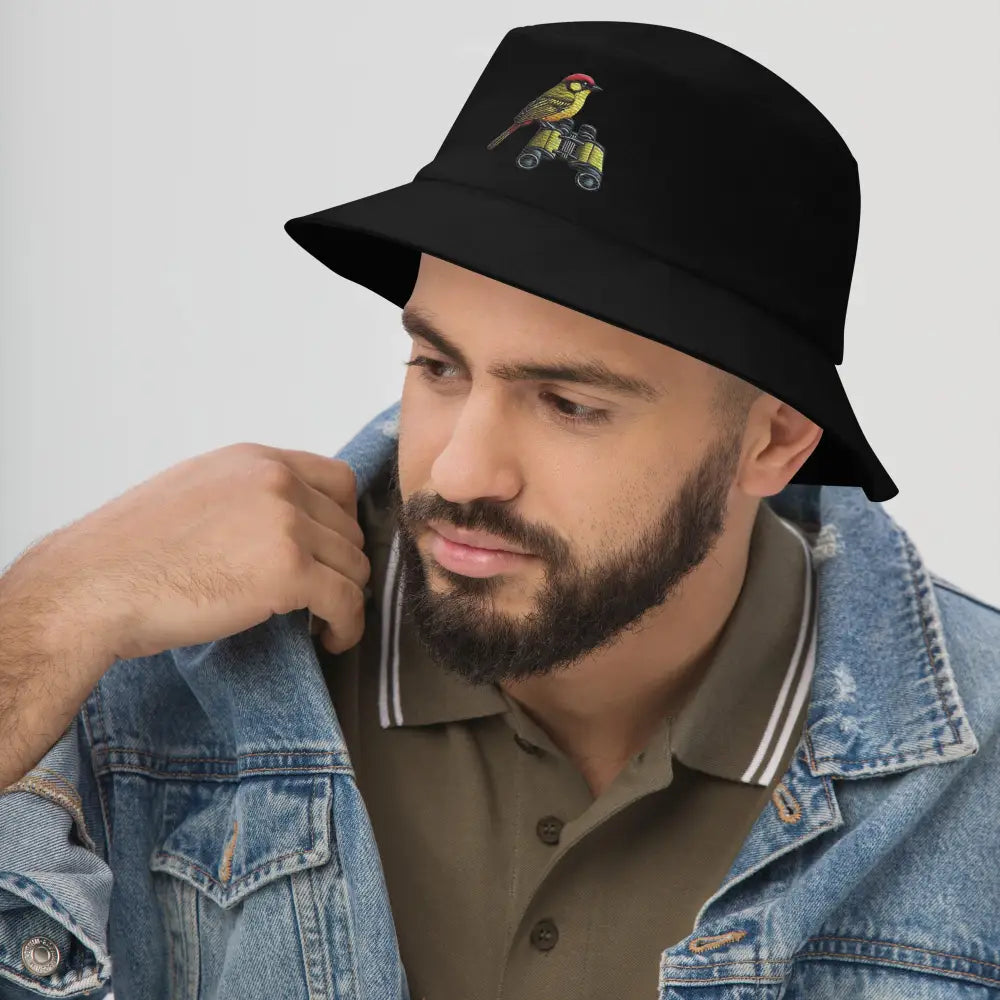Man in Trini Skies bird watcher bucket embroidered hat with denim jacket