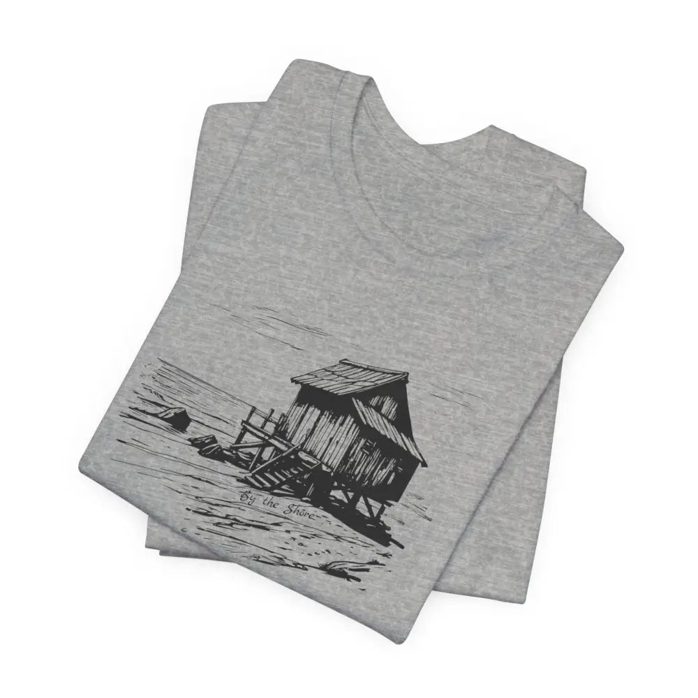 Trini Skies shore cabin tee: folded gray T-shirt with stilt house drawing