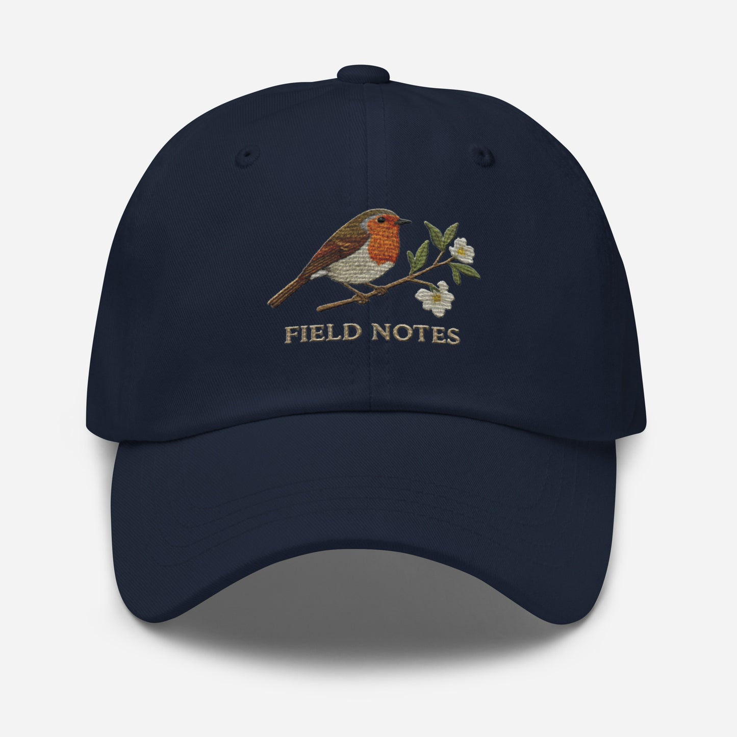 Navy blue dad hat with embroidered robin bird, flowers, and Field Notes on vintage cotton twill