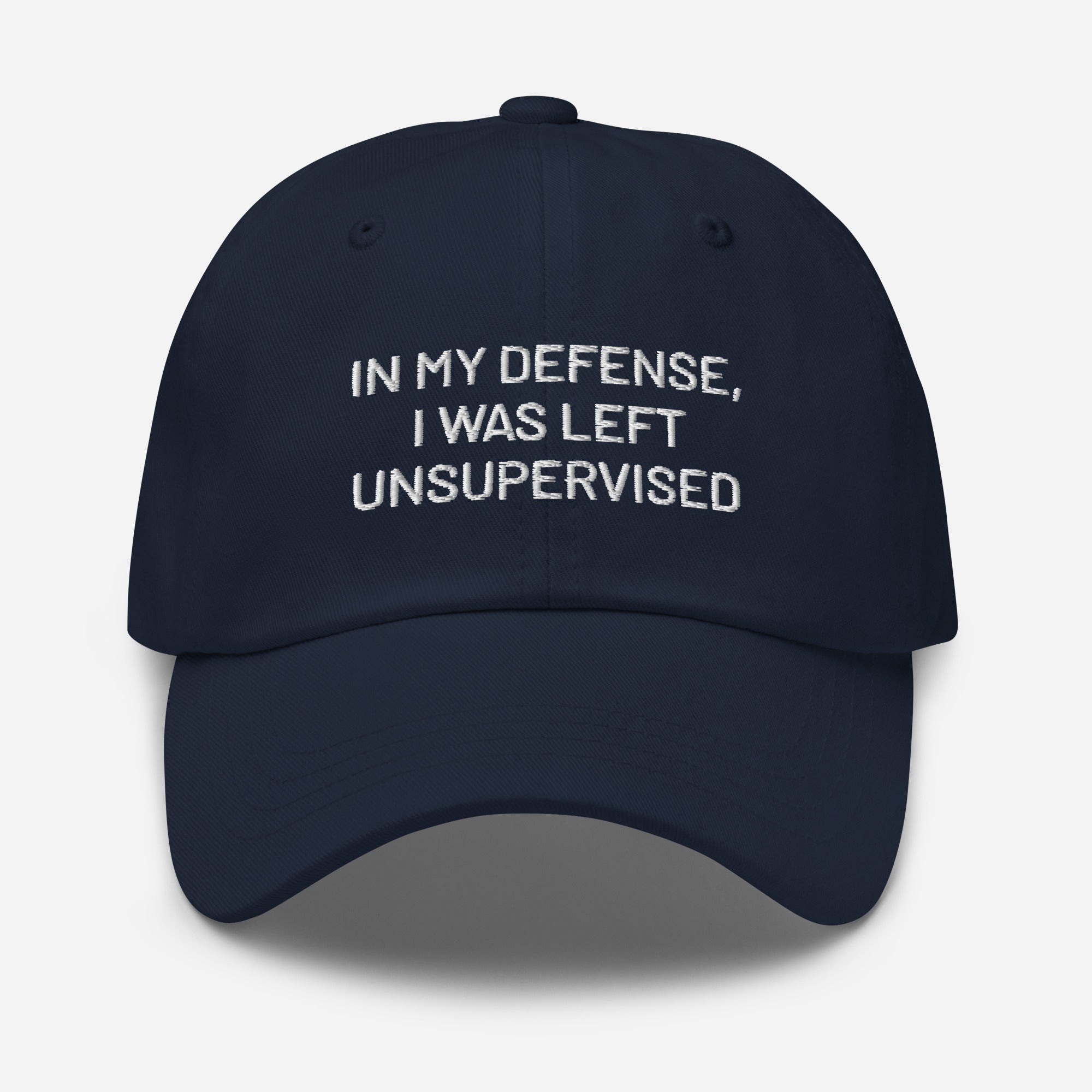 Navy blue embroidered dad hat with funny In My Defense I Was Left Unsupervised text