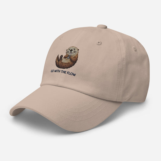 Beige dad cap with go with the flow otter minimalist wildlife design
