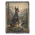 Doberman pinscher on rocky outcrop by stream, Trini Skies Graphics cotton protector’s blanket