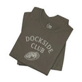 Folded olive green Dockside Club Tee with oyster shell graphic by Trini Skies Supply
