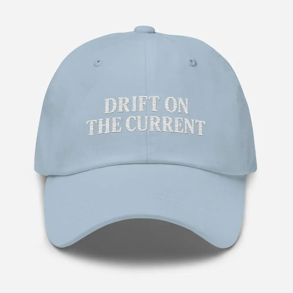 Light blue premium Yupoong unstructured dad cap with Trini Skies Supply embroidered Drift on the Current design