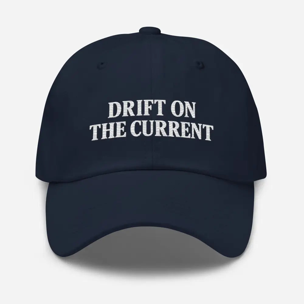 Dark blue premium Yupoong unstructured dad cap with Trini Skies Supply Drift on the Current embroidery