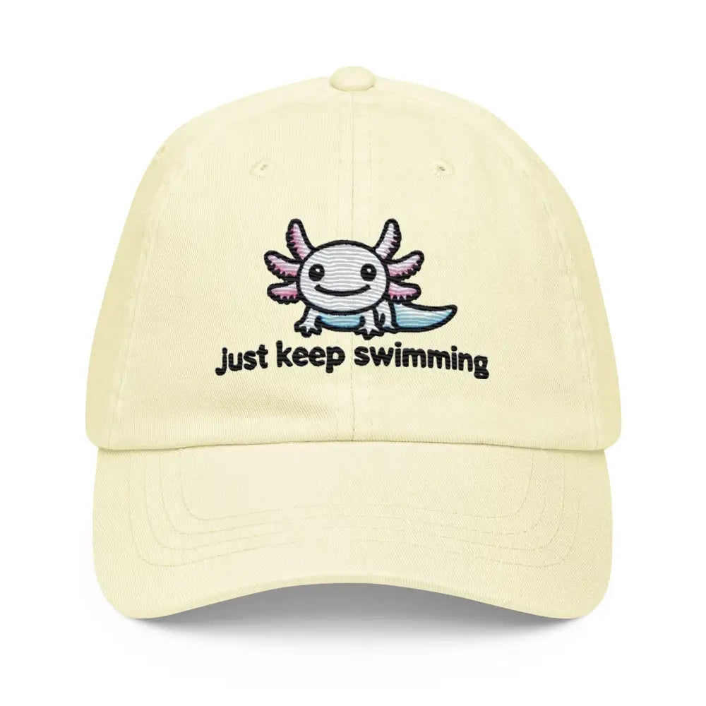 Light yellow pastel baseball hat with embroidered axolotl and Just keep swimming