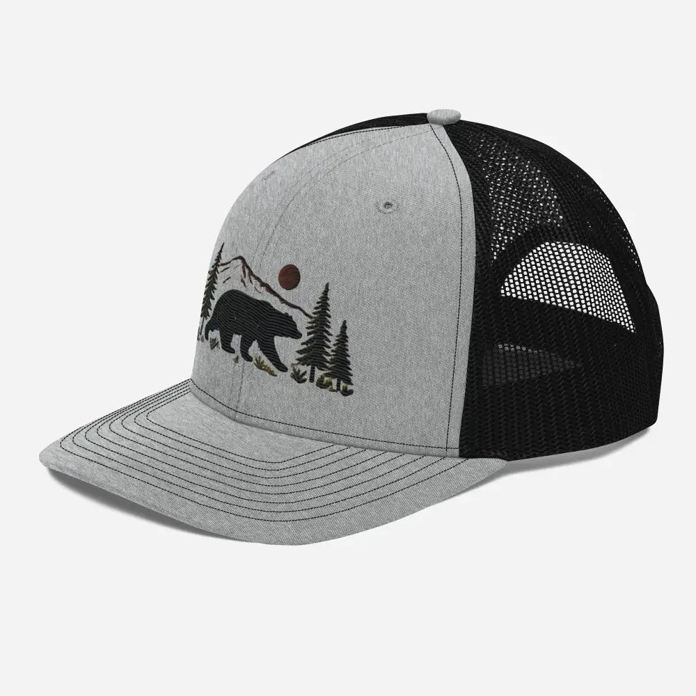 Embroidered black bear wildlife trucker cap with mountains and trees