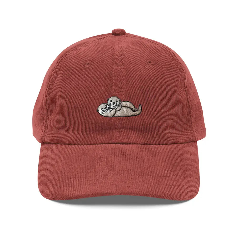 Maroon embroidered corduroy cap with cuddling otters design