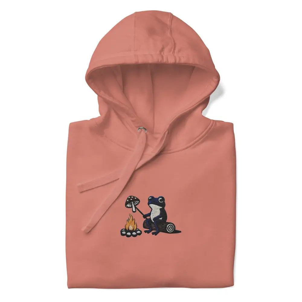 Peach unisex hoodie with embroidered frog roasting mushroom over campfire, soft ring-spun cotton