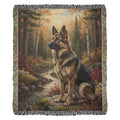 Woven cotton wilderness blanket of German Shepherd by creek in autumn forest