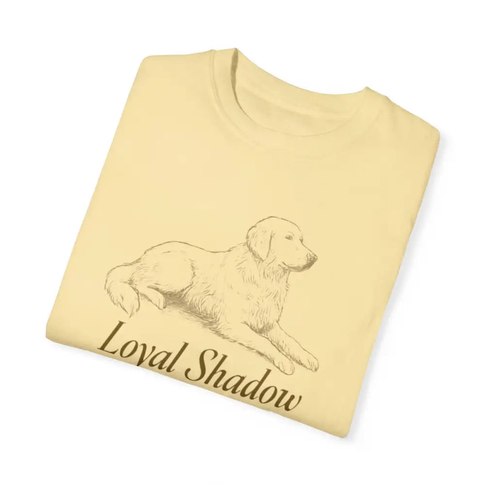 Folded pale yellow unisex garment-dyed t-shirt with golden retriever graphic