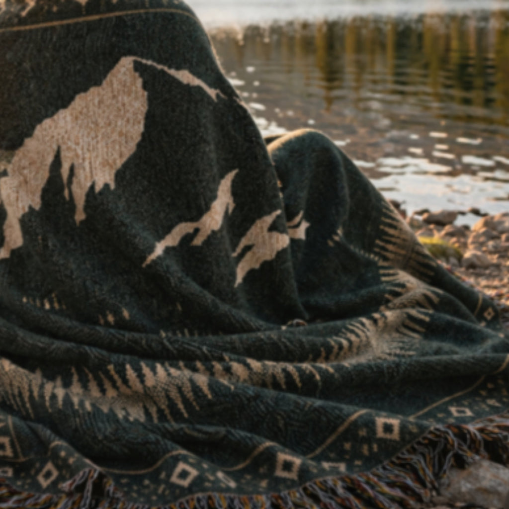 Close-up of Aspen Veil jacquard weave — mountain silhouette and geometric border in 100% cotton thread