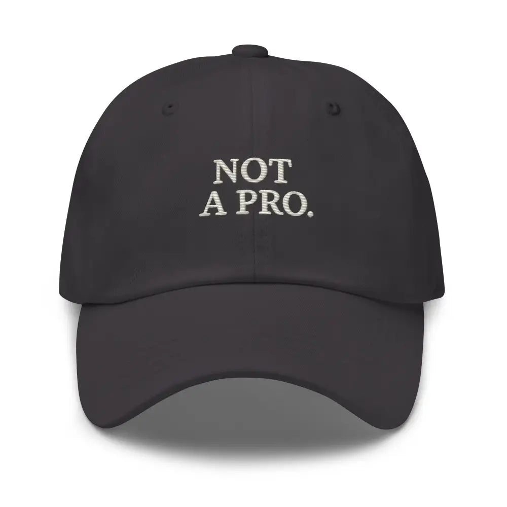 Dark gray minimalist dad hat with white Not a Pro Golf embroidery