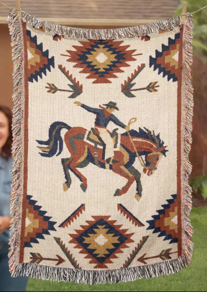 Southwest rodeo cowboy on woven western heritage blanket in cream, navy, rust