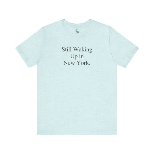 Light blue minimalist Bella Canvas NYC shirt with Still Waking Up in New York graphic