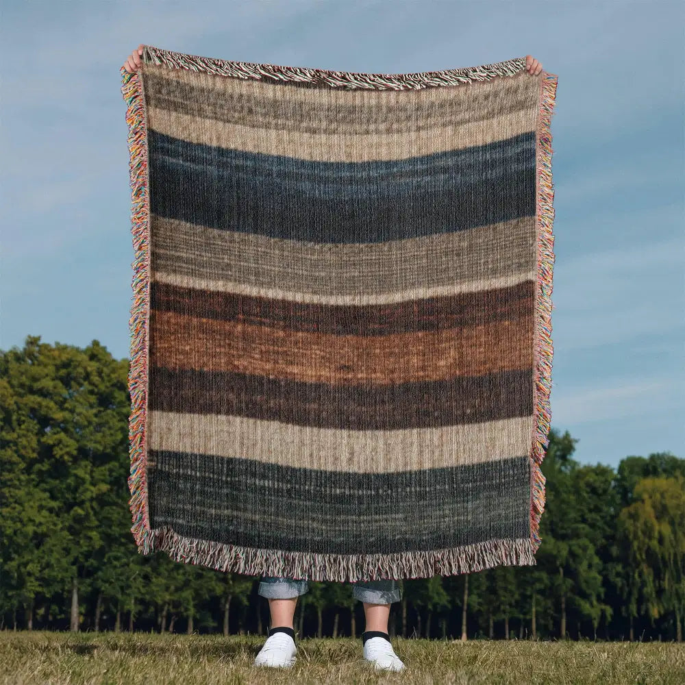 Striped woven blanket in neutral lodge-inspired cotton tapestry with earthy stripes