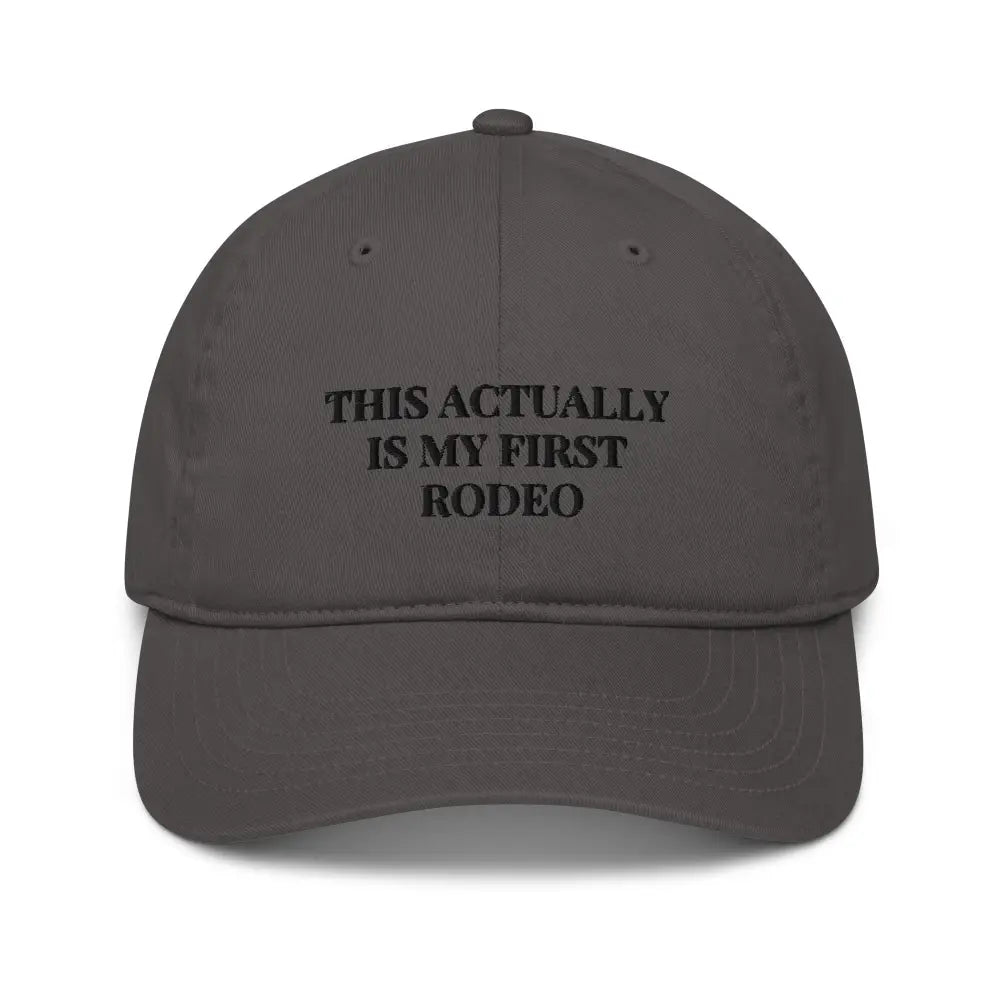 Dark gray rodeo embroidered organic baseball cap with text on front