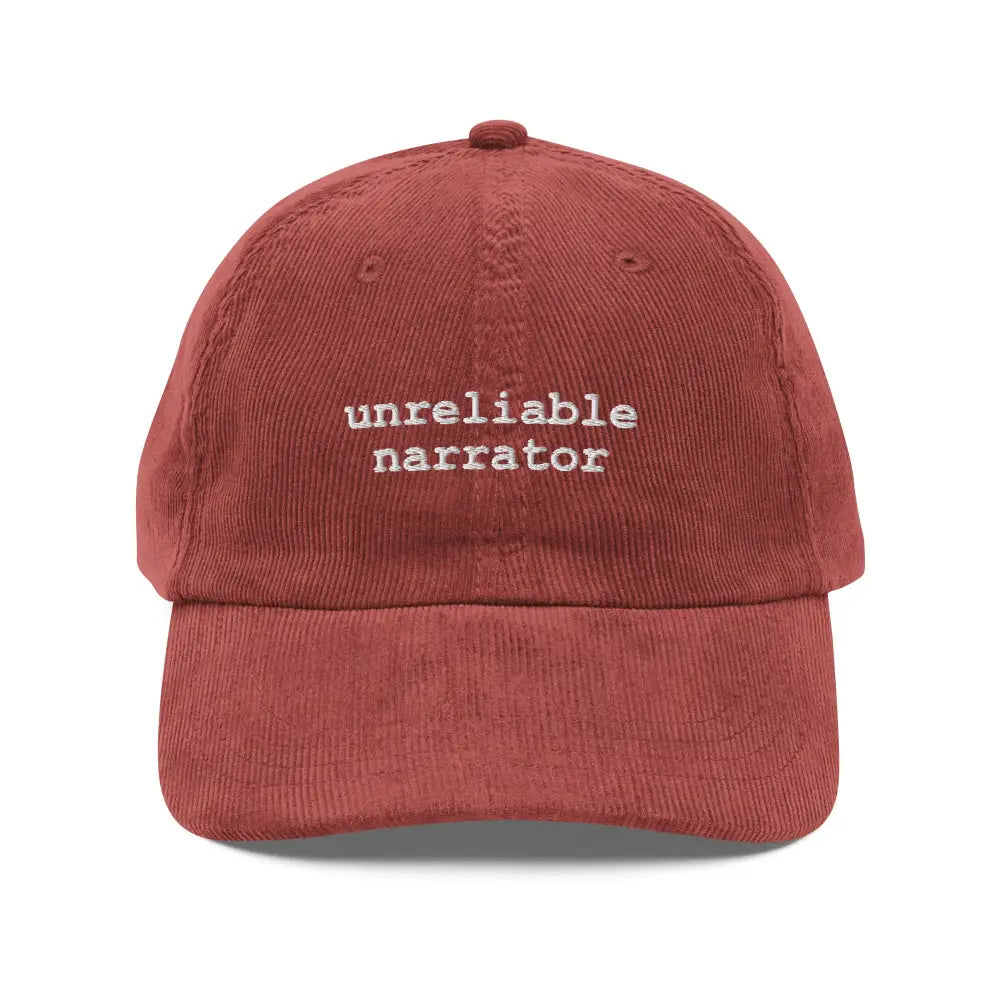 Rust-colored corduroy baseball cap with embroidered unreliable narrator text by Trini Skies