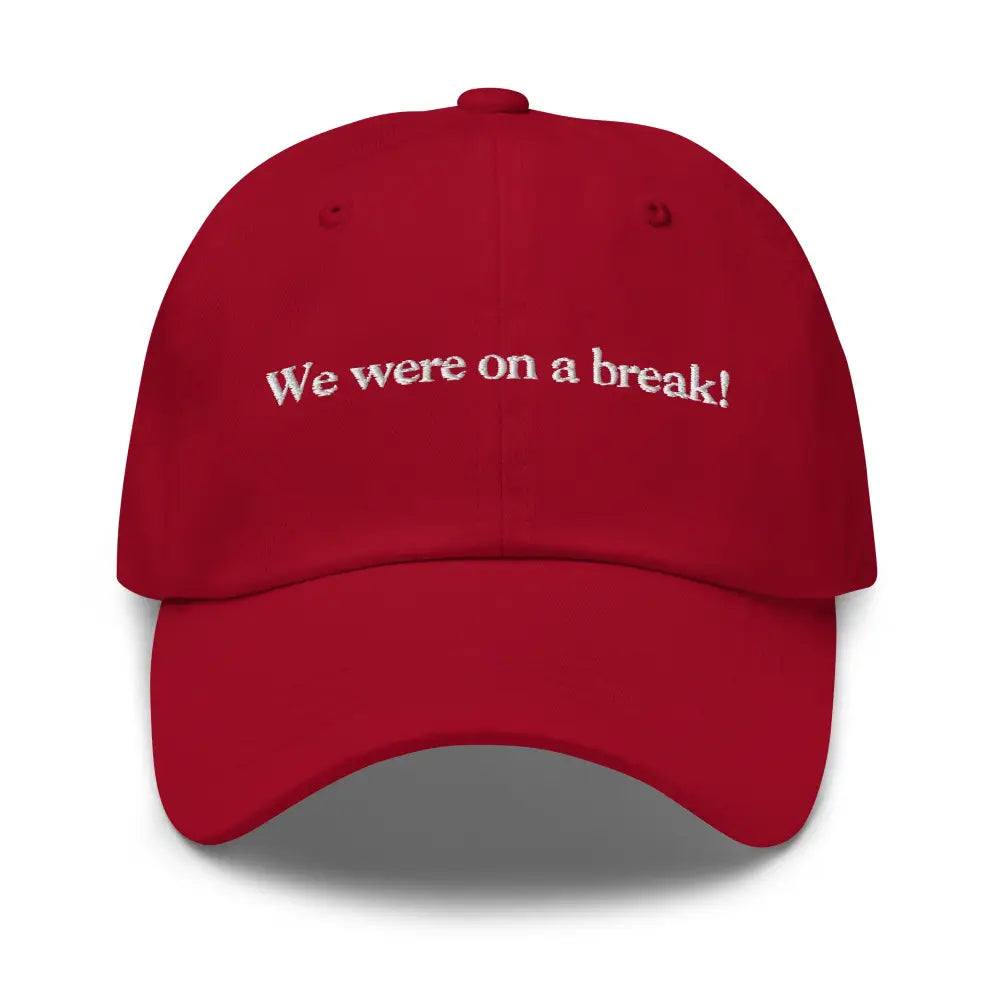 Red baseball cap with white embroidered text dad hat